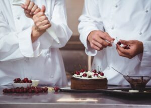 [freepicdownloader.com]-chefs-decorating-cake-they-just-made-large
